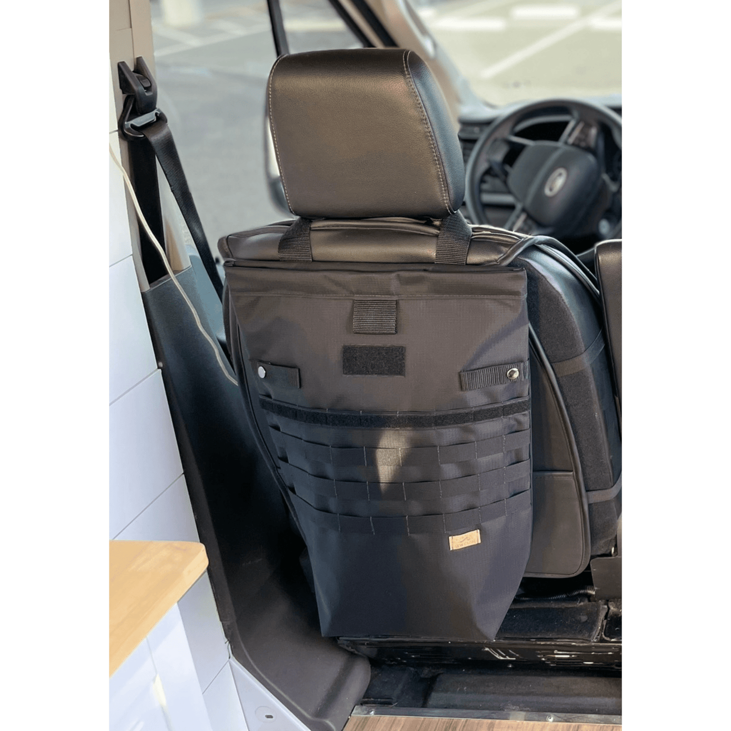 Tactical seat back organizer with MOLLE straps installed in a camper van